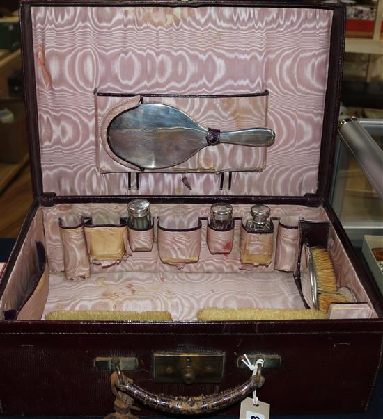 A George V Asprey & Co leather travelling toilet case containing eight silver mounted jars etc, case 17.75in.